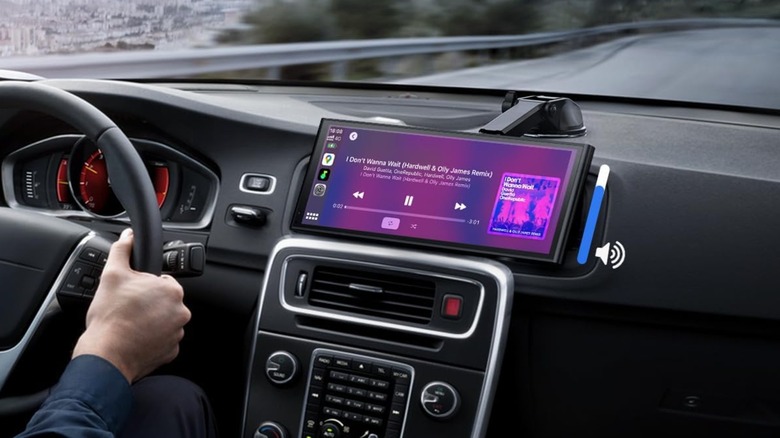 A pink-lit infotainment screen on dashboard