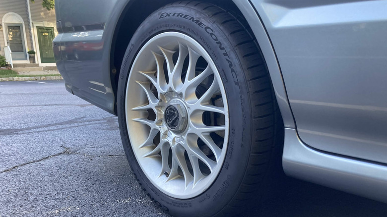 Continental ExtremeContact DWS-06 tire on car's rear-right quarter panel