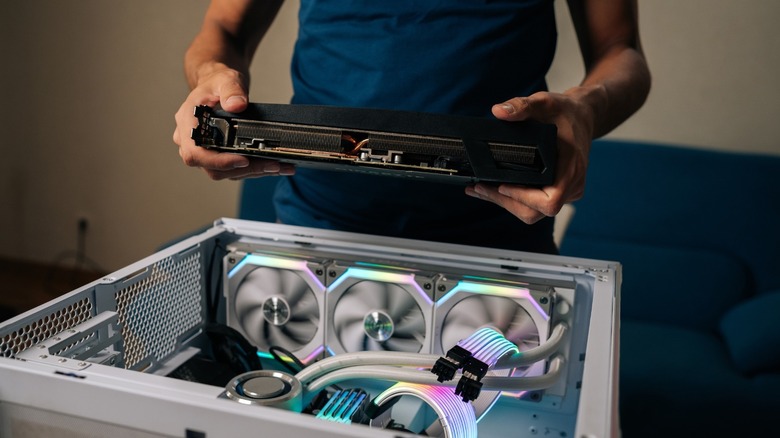 a person assembling a gaming computer.