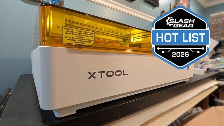 XTool M2 laser cutter and CMYK printer machine on desk.