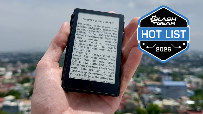 A hand holding the XTEINK X4 Pro outside