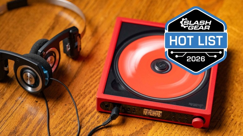 The FiiO DM15 R2R next to Kos headphones on a table top.