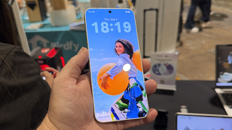 Hand holding the Tecno Camon Slim 5G