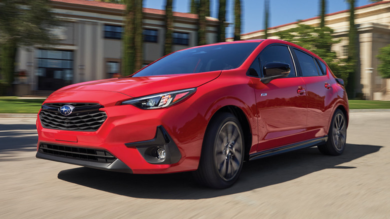 2026 Subaru Impreza in red driving down road