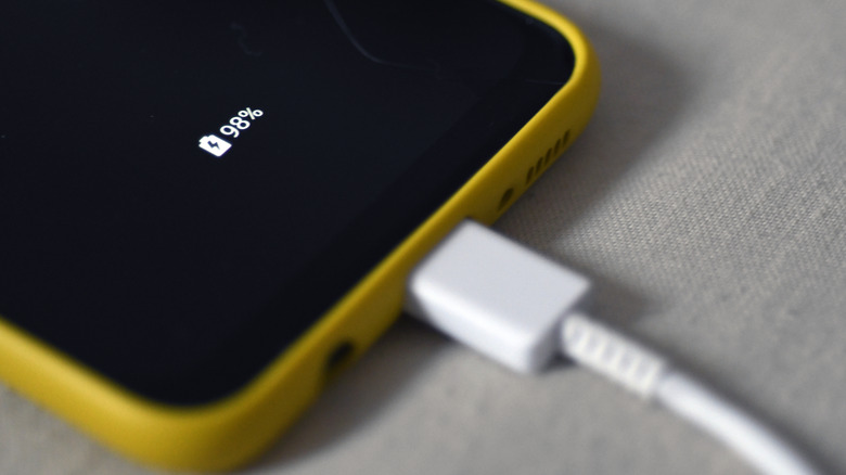 Smartphone connected to charger.