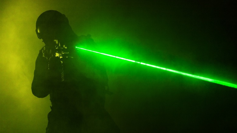 Riot officer aiming laser gun