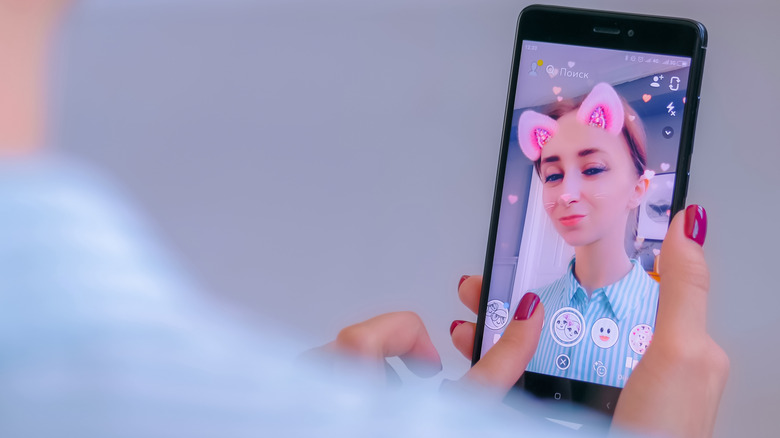Girl using Snapchat filter