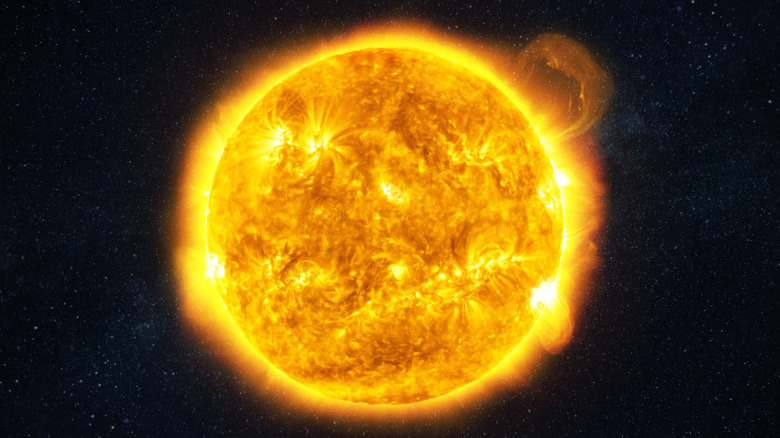 Bright sun burns with plasma and flares in space.