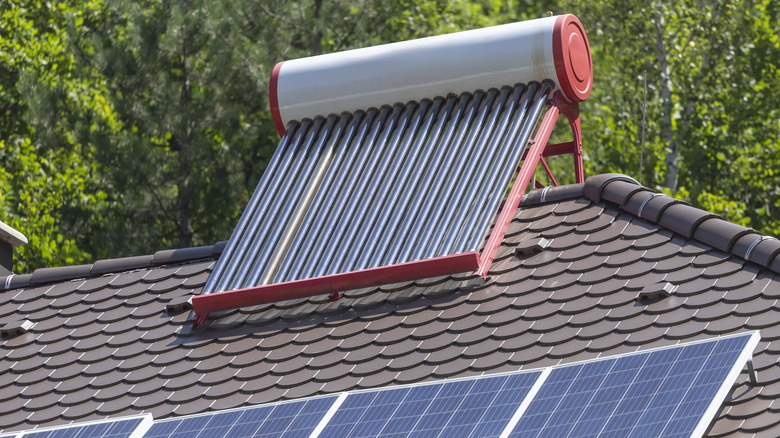 Solar powered hot water boiler on rooftop of house.
