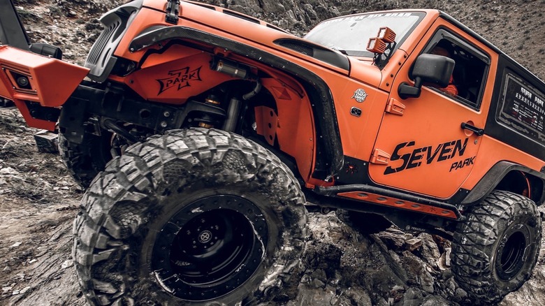 orange jeep wrangler rock crawler