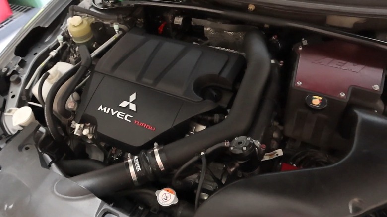 The engine bay of a Lancer after battery was moved to the trunk