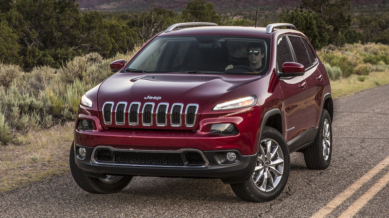 2015 Jeep Cherokee red parked road