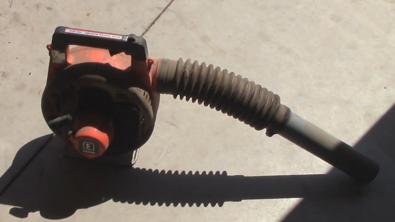A vintage Echo leaf blower on the ground.