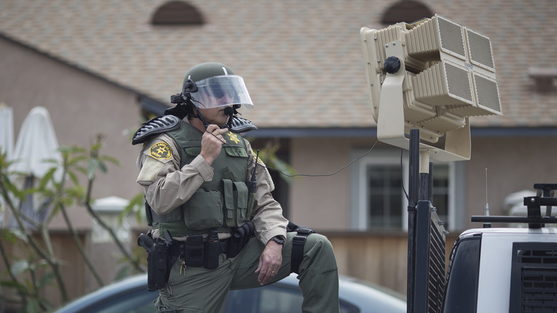 Officer using sonic weapon truck