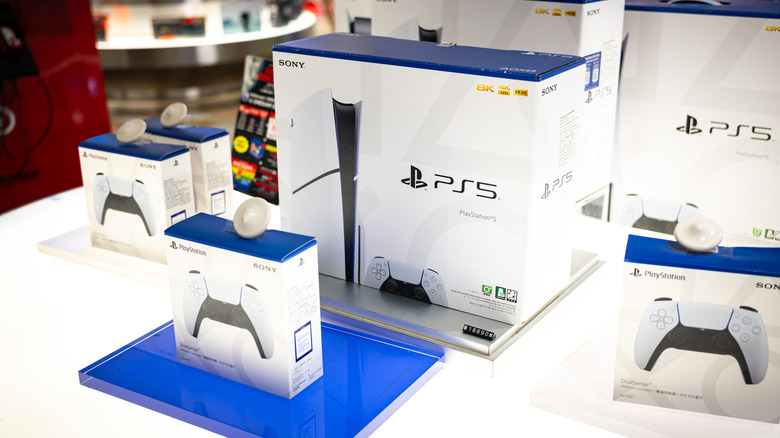 A display of PlayStation 5 gaming consoles and controllers in a store