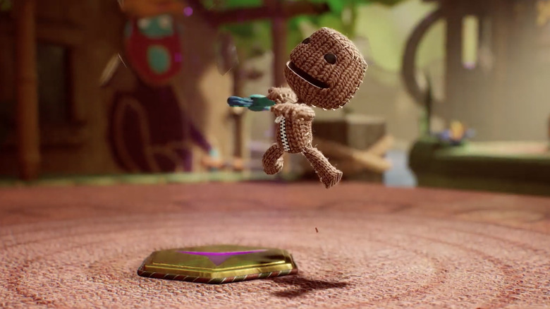 Sackboy jumping over emblem