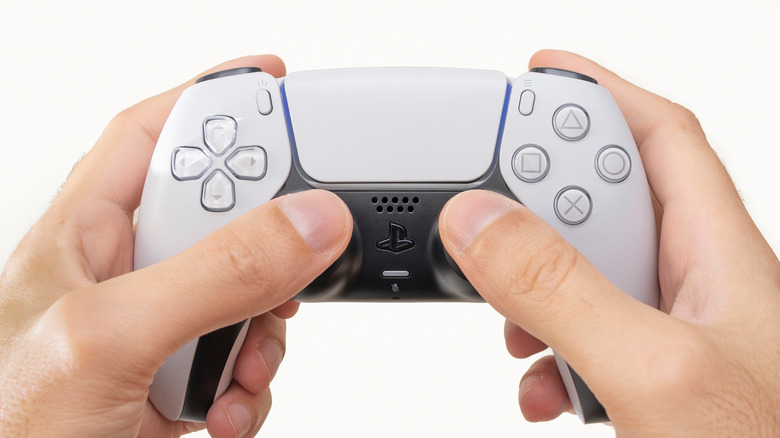 Hands holding a PS5 DualSense controller