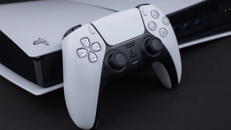 A PlayStation 5 controller resting on a PlayStation 5 console.