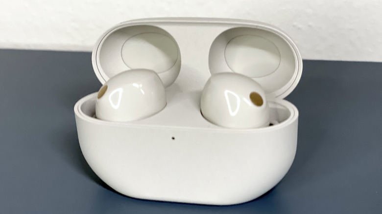 WF-1000XM5 earbuds inside charging case with lid open