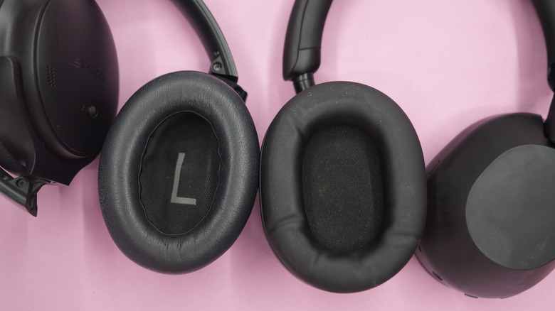 A pair of Sony XM5 headphones (left) and Bose QC45s (right) showing a close up of the earcups.