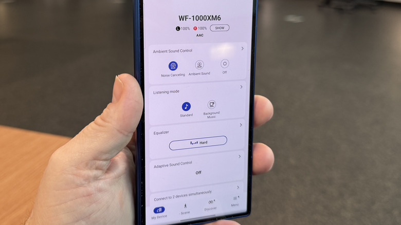 Man holding a phone with the app open