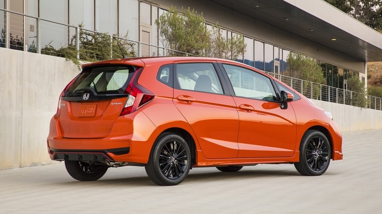 Orang 2020 Honda Fit parked in front of a building