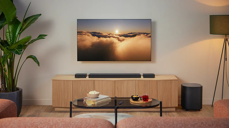 A living room with a mounted TV and a soundbar below it.