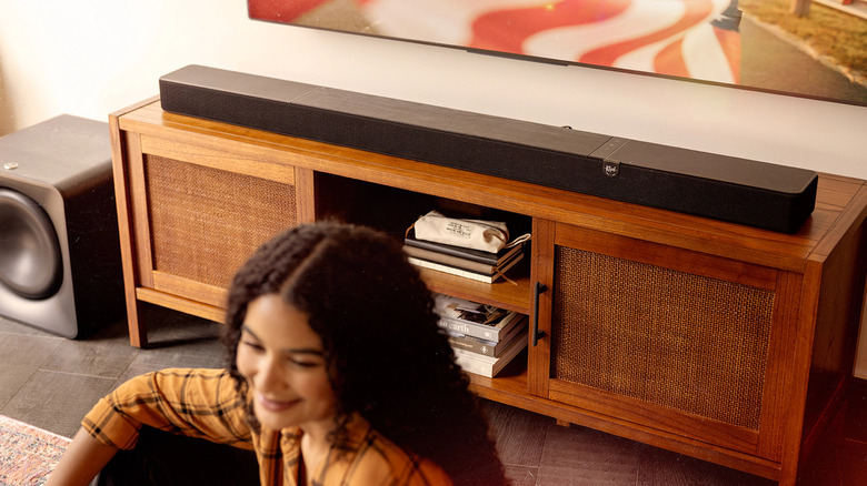 A soundbar placed below a TV.