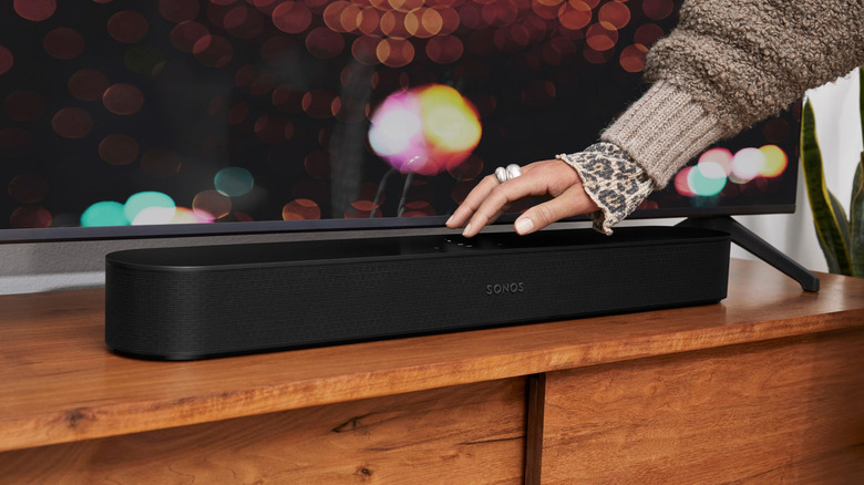 A hand placed on a Sonos soundbar.