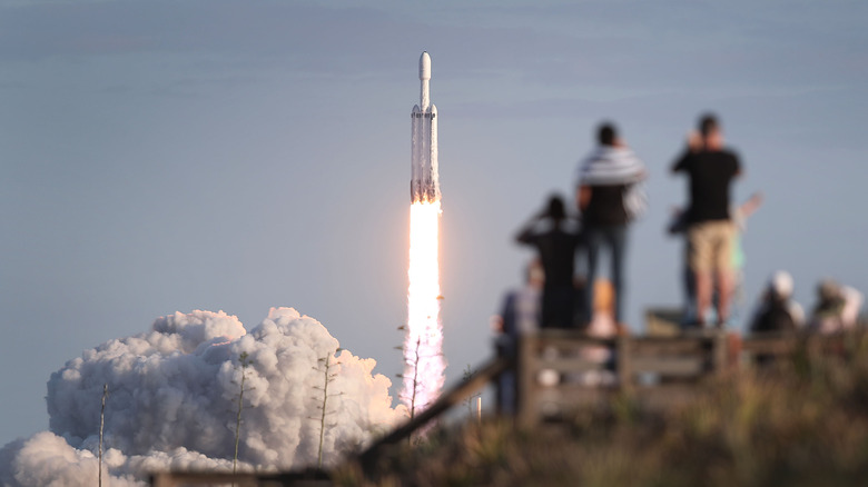 Onlookers watch as SpaceX's Falcon Heavy launches