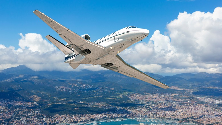 Private jet over harbor