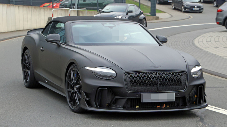 An alleged matte-black Bentley Continental Superports convertible driving on a public road.
