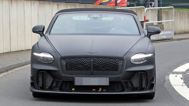 An alleged matte-black Bentley Continental Superports convertible driving on a public road.