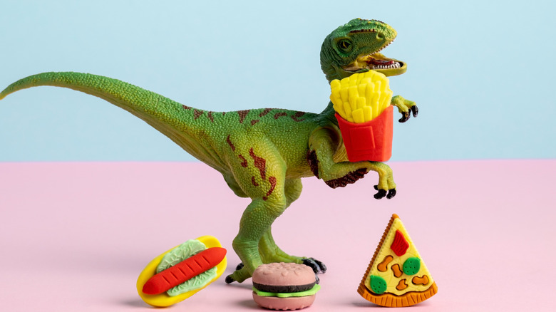 Dinosaur eating junk food