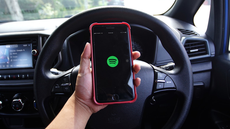 Spotify on iPhone in front os steering wheel
