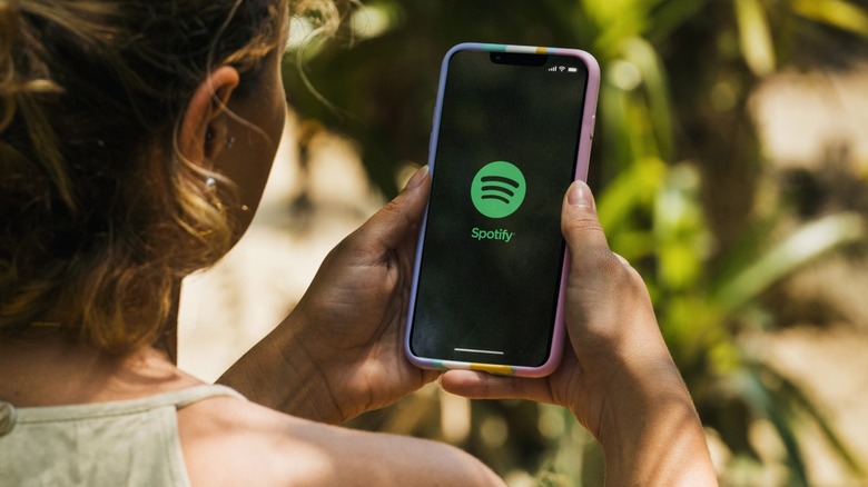 Spotify on phone held in hands