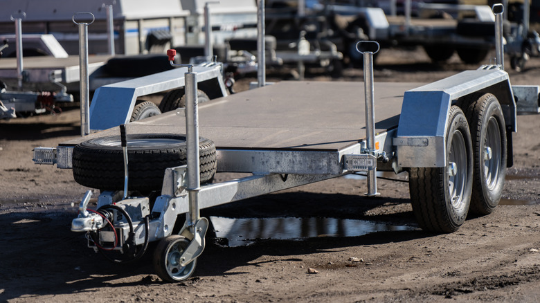 Metal car hauler trailer in outdoor machinery yard