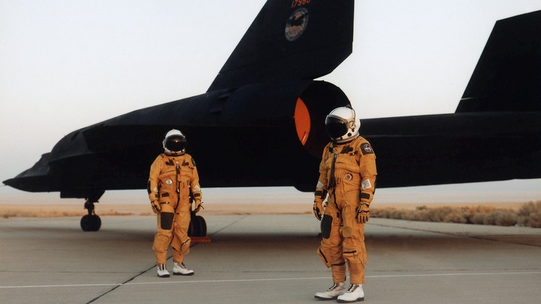 The crew of a NASA Lockheed SR-71 Blackbird standing by the aircraft in their pressurized flight suits