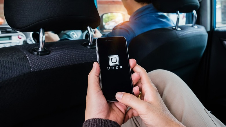 Uber on phone in passenger's hands