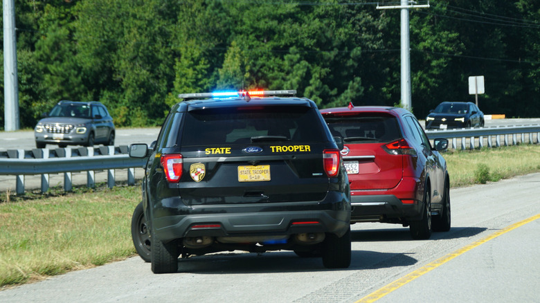 state trooper pulls over driver on highway