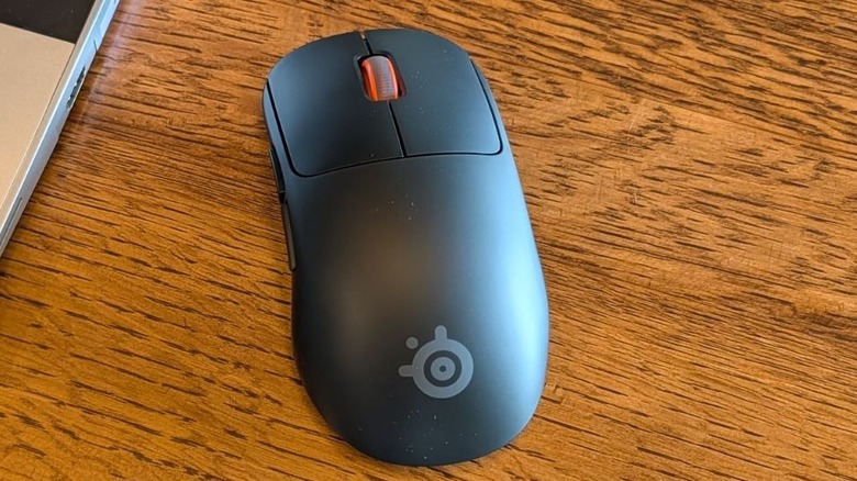 SteelSeries Sensei Pro mouse next to open laptop