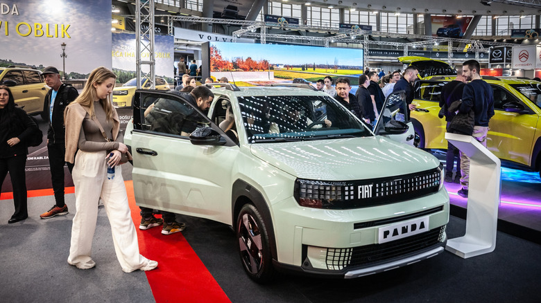 A Fiat Grande Panda in pastel green on display at the Belgrade Motor Show, front 3/4 view