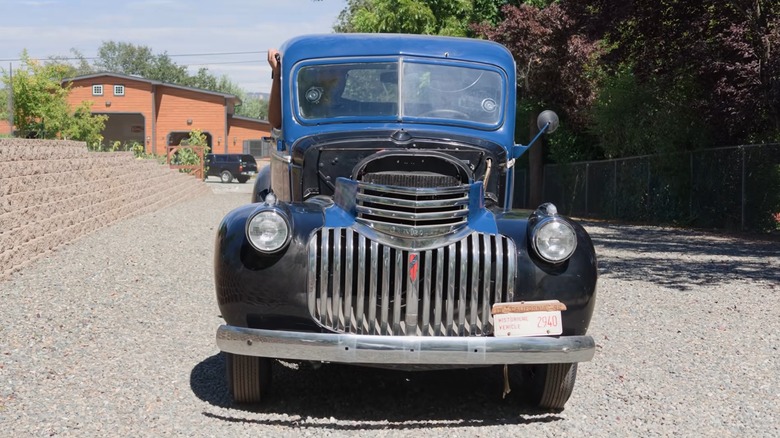 A 1942 Chevy pickup driving on a road.