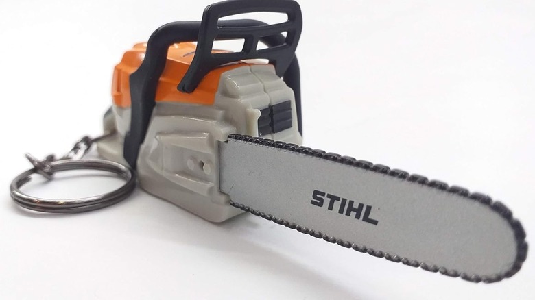 A Stihl chainsaw keychain against a white background.