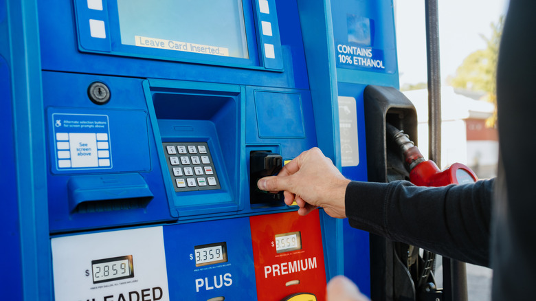 Person paying for gas with a credit card