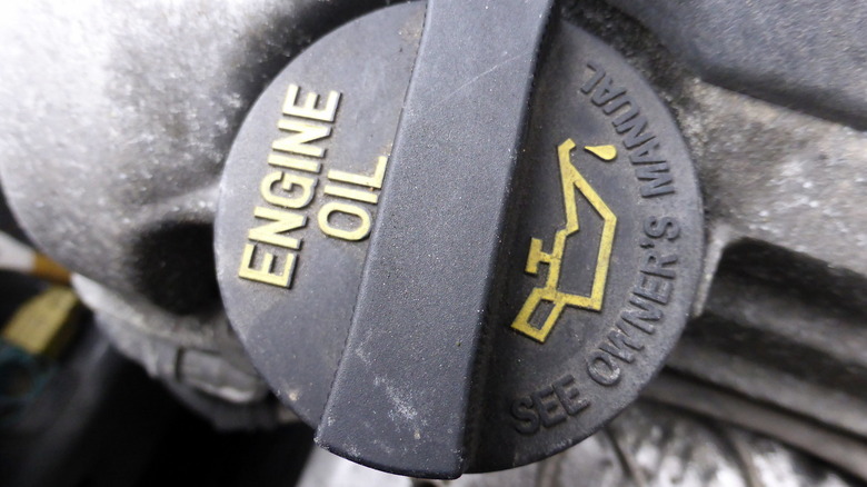 A closeup of the engine oil cap on a car.