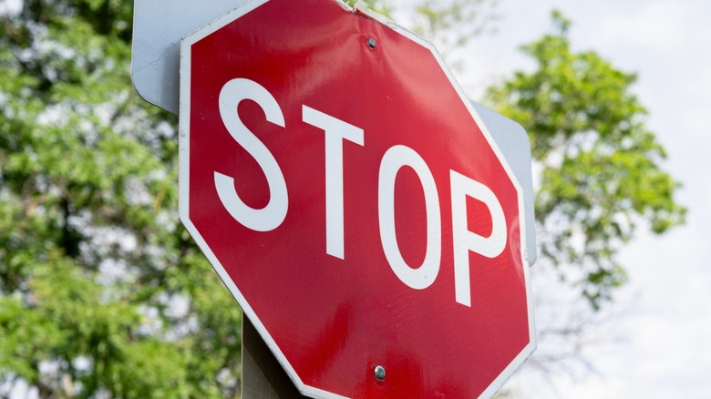 stop sign with a tree in the background