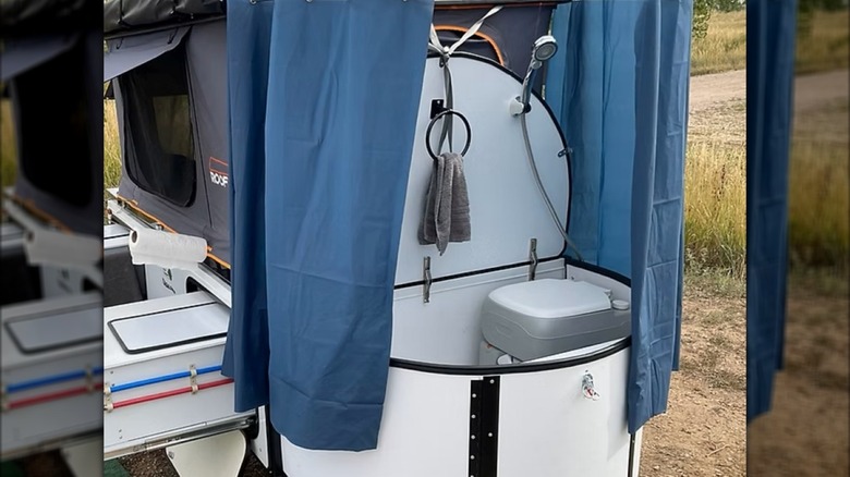 The Tag-Along's bathroom area complete with showerhead and privcy curtain.