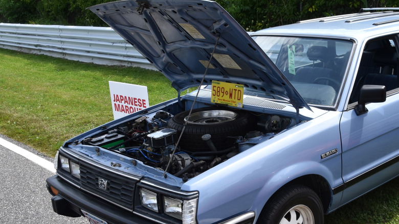 1984 Subaru GL with hood open showing engine and and spare tire
