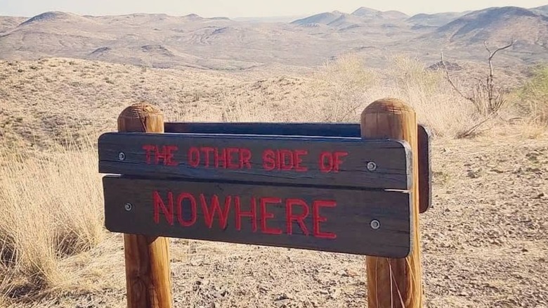A sign reading "The Other Side of Nowhere" in Big Bend National Park, Texas.